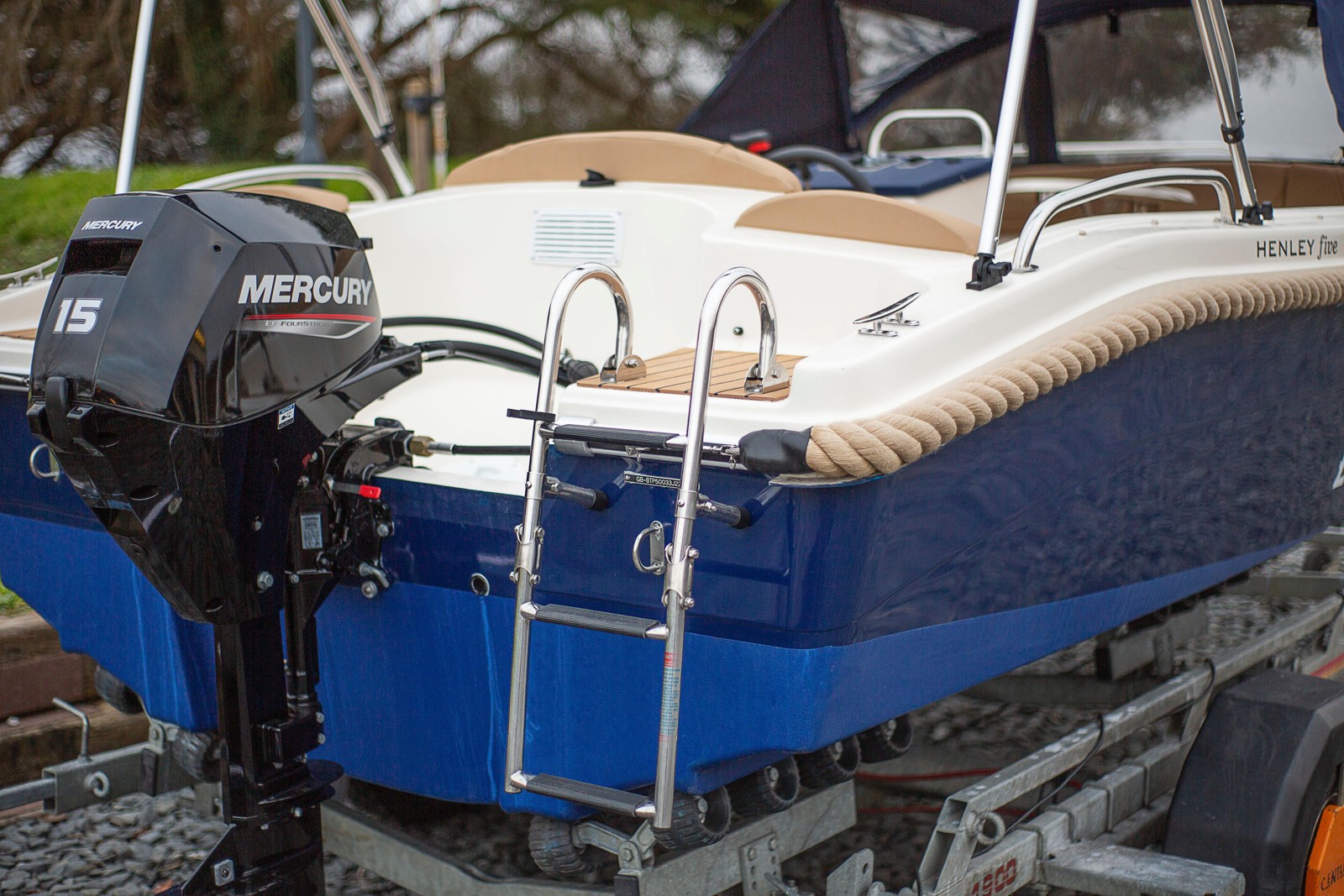 Sebring Marine's blue and white Henley Five day boat with an outboard motor